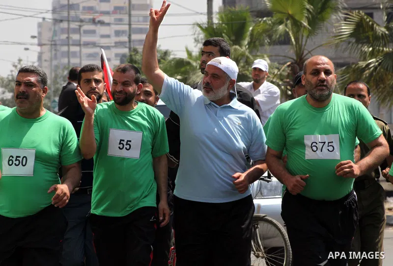 The head of Gaza's Hamas government, Ismail Haniya (blue polo shirt), takes part in a marathonin Gaza on May 15, 2012. 'Nakba' Day for the Palestinians is an annual day of commemoration of the displacement that followed...