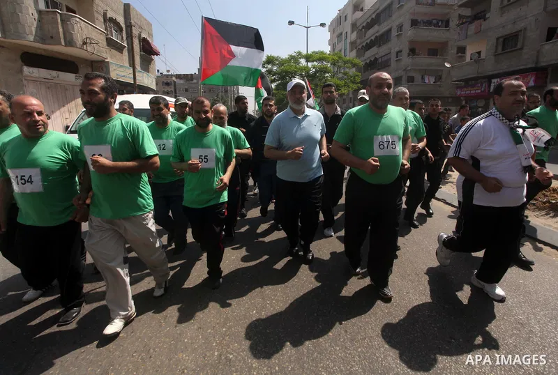 The head of Gaza's Hamas government, Ismail Haniya (blue polo shirt), takes part in a marathonin Gaza on May 15, 2012. 'Nakba' Day for the Palestinians is an annual day of commemoration of the displacement that followed...