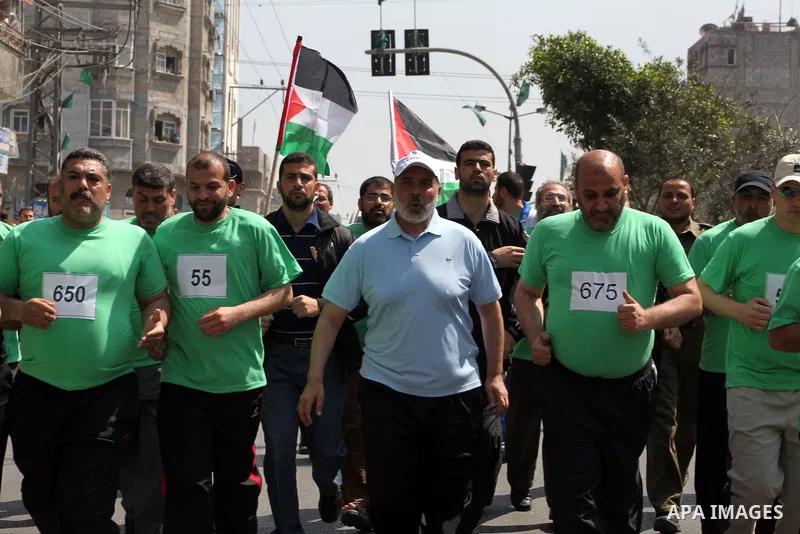 The head of Gaza's Hamas government, Ismail Haniya (blue polo shirt), takes part in a marathonin Gaza on May 15, 2012. 'Nakba' Day for the Palestinians is an annual day of commemoration of the displacement that followed...
