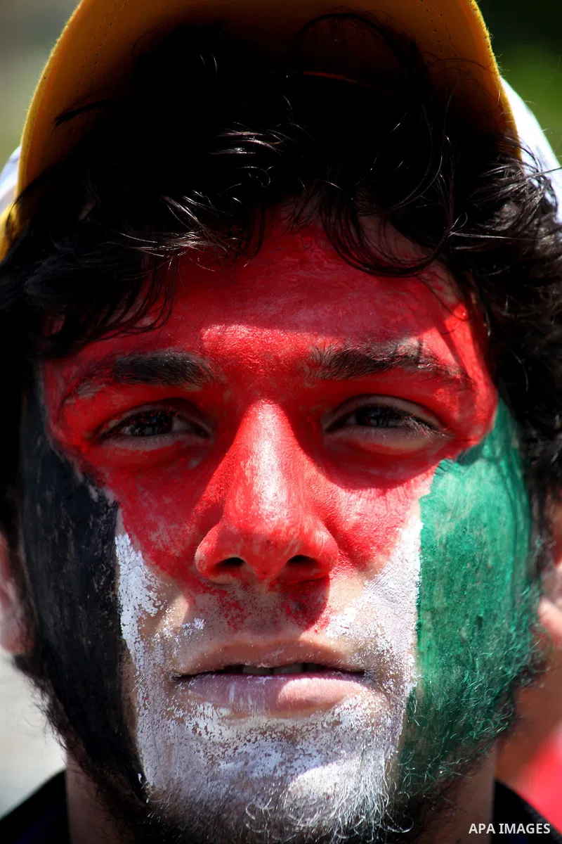 A Palestinian with his face painted in the colours of the Palestinian flag takes part in a rally marking Nakba in Gaza City May 15, 2012. Israeli security forces were on high alert for violence on Tuesday, the day when P...