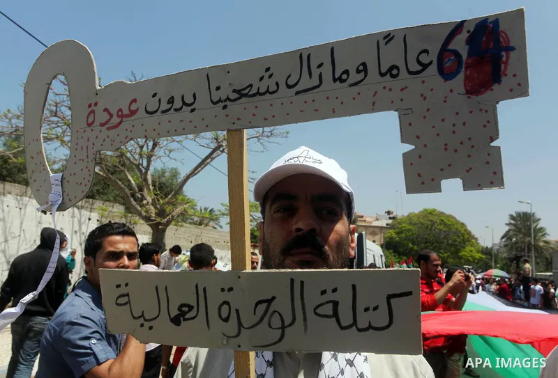 Palestinians hold keys symbolizing keys to houses left by Palestinians in 1948. Palestinians take part in a mass demonstration in front of UN headquarters of UNESCO marking Nakba when Palestinians were forced to leave th...