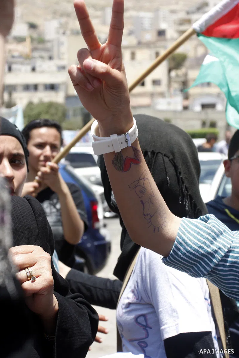 Palestinians participate in a rally marking the 64th anniversary of "Nakba", Arabic for catastrophe, the term used to mark the events leading to Israel's founding in 1948, in the West Bank city of Nablus, Tuesday, May 15...
