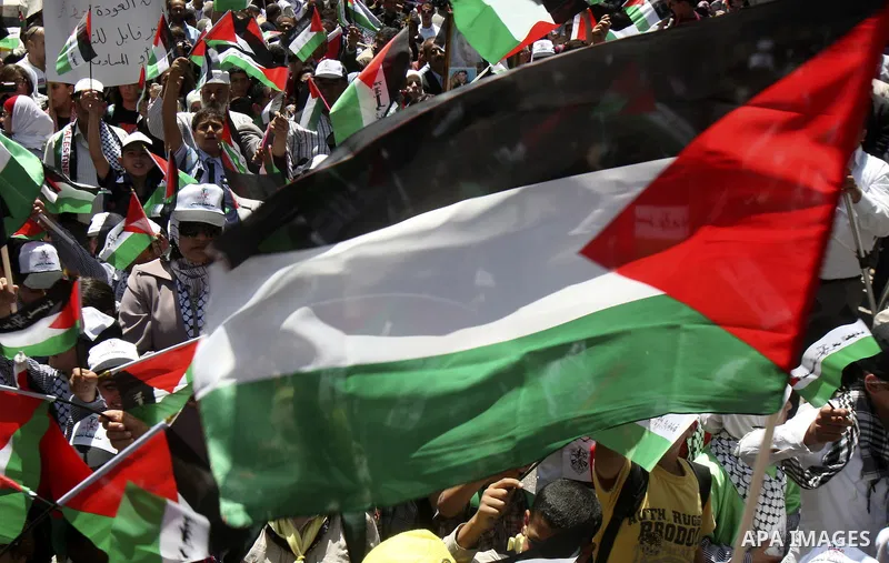 Palestinians participate in a rally marking the 64th anniversary of "Nakba", Arabic for catastrophe, the term used to mark the events leading to Israel's founding in 1948, in the West Bank city of Nablus, Tuesday, May 15...