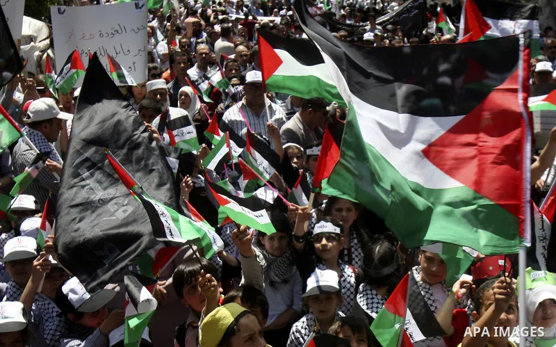 Palestinians participate in a rally marking the 64th anniversary of "Nakba", Arabic for catastrophe, the term used to mark the events leading to Israel's founding in 1948, in the West Bank city of Nablus, Tuesday, May 15...