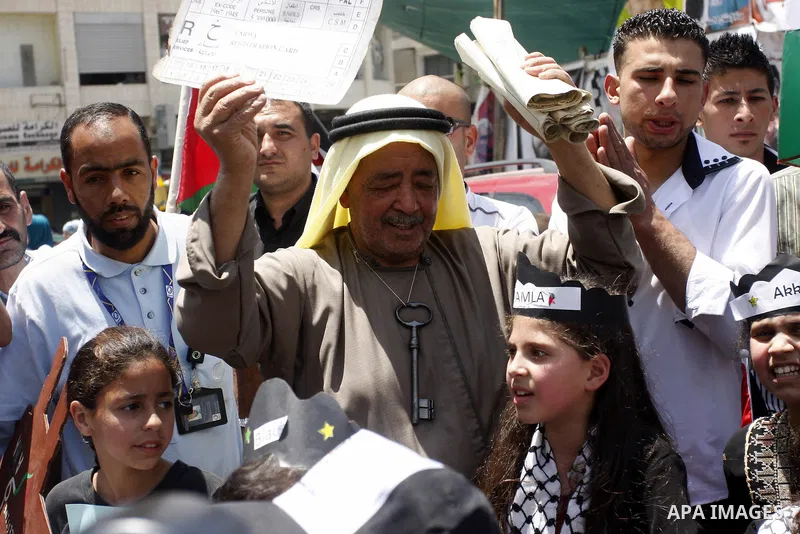 Palestinians hold certificate during a protest marking the anniversary of the "Nakba", Arabic for catastrophe , during a rally marking the 64rd anniversary of the Nakba, or catastrophe, the Arabic term used to describe t...