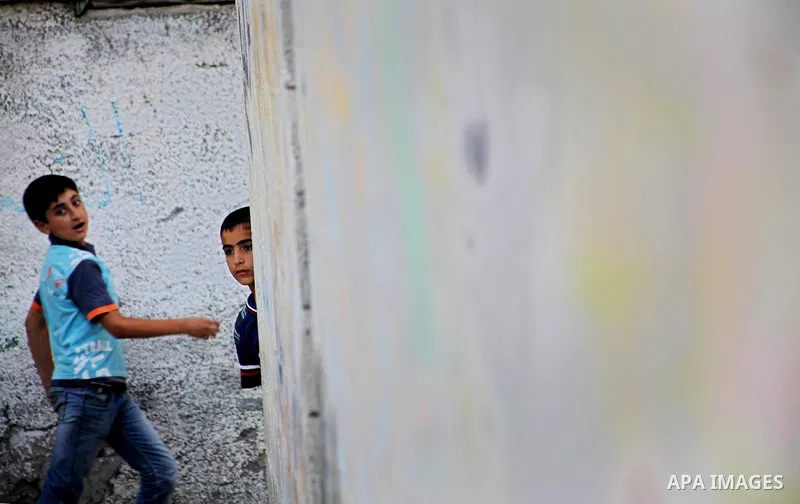 Palestinian children play in front of their homes in the Shati Palestinian refugee camp in Gaza City on May 15, 2012, as Palestinians and Arab-Israelis marked Nakba day, which commemorates the exodus of hundreds of thous...