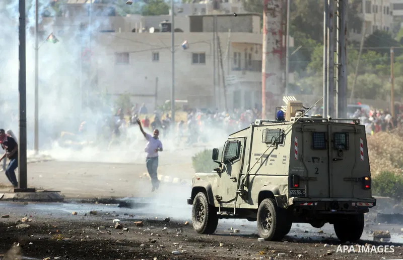 Palestinian protesters throw stones towards Israeli border police during clashes on Nakba Day near Ofer prison, near Ramallah, the West Bank, 15 May 2012. Thousands marched in the West Bank and Gaza Strip, commemorating...