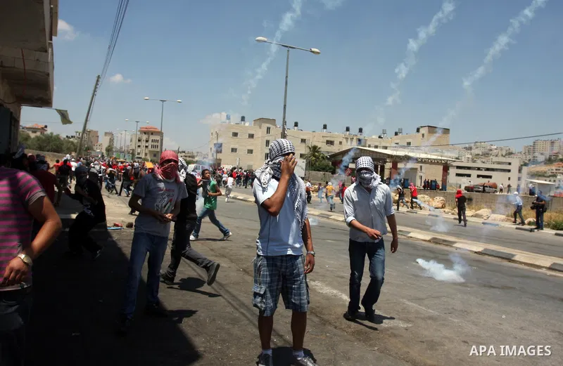 Palestinian protesters throw stones towards Israeli border police during clashes on Nakba Day near Ofer prison, near Ramallah, the West Bank, 15 May 2012. Thousands marched in the West Bank and Gaza Strip, commemorating...