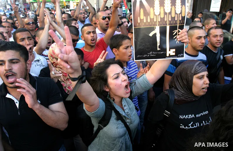 Palestinians protest outside Damascus gate in Jerusalem's Old City, during a 'Nakba Day' rally and march in East Jerusalem, 15 May 2012. Palestinians mark the Nakba, or the 'catastrophe', of israel's gaining statehood an...
