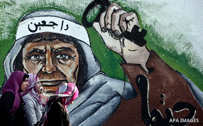 Palesstinians past newly painted mural on the 64th anniversary of "Nakba", Arabic for catastrophe, the term used to mark the events leading to Israel's founding in 1948, in Gaza City, Tuesday, May 15, 2012. Hundreds of t...