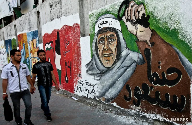 Palesstinians past newly painted mural on the 64th anniversary of "Nakba", Arabic for catastrophe, the term used to mark the events leading to Israel's founding in 1948, in Gaza City, Tuesday, May 15, 2012. Hundreds of t...