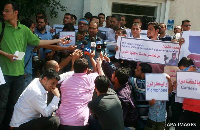 Palestinian journalists and photographers speak during press conference in a protest in support with the photographer, Mohamed Osman, in front of Palestinian Centre for Human Rights in Gaza city on May 16, 2012. Photo by...