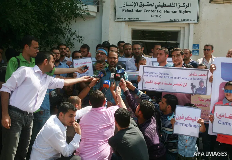 Palestinian journalists and photographers speak during press conference in a protest in support with the photographer, Mohamed Osman, in front of Palestinian Centre for Human Rights in Gaza city on May 16, 2012. Photo by...