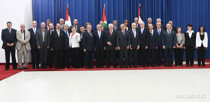 Palestinian National Authority President Mahmoud Abbas and with members of the new cabinet after the swearing in ceremony of the new cabinet, at Abbas's headquarters in the West Bank town of Ramallah, on 16 May 2012. Abb...