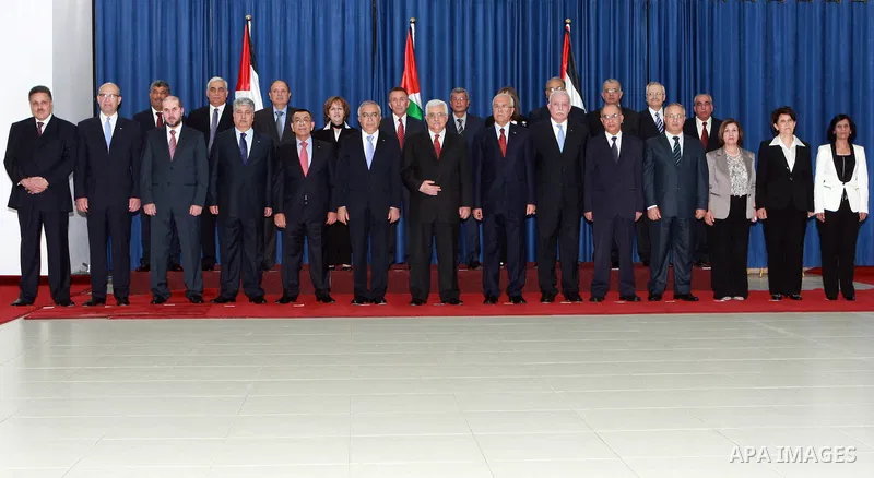 Palestinian National Authority President Mahmoud Abbas and with members of the new cabinet after the swearing in ceremony of the new cabinet, at Abbas's headquarters in the West Bank town of Ramallah, on 16 May 2012. Abb...