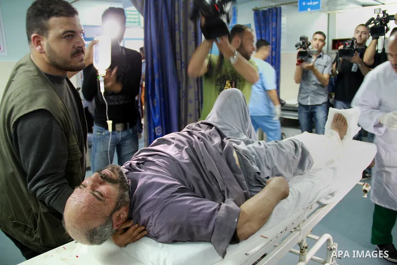 Palestinian medics receive a wounded man for treatment at a hospital in Gaza City on May 17, 2012, following Israeli shelling into the Gaza Strip in which seven people were wounded, two of them in critical condition, nea...