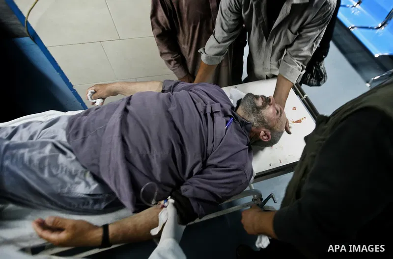 Palestinian medics receive a wounded man for treatment at a hospital in Gaza City on May 17, 2012, following Israeli shelling into the Gaza Strip in which seven people were wounded, two of them in critical condition, nea...