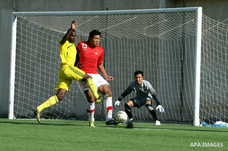 Mauritanian and Indonesian footballers fight for possession during a football match. Mauritanian and Indonesian footballers face-off during the Nakba Championship in the West Bank city of Nablus, on May 17, 2012. Nakba f...