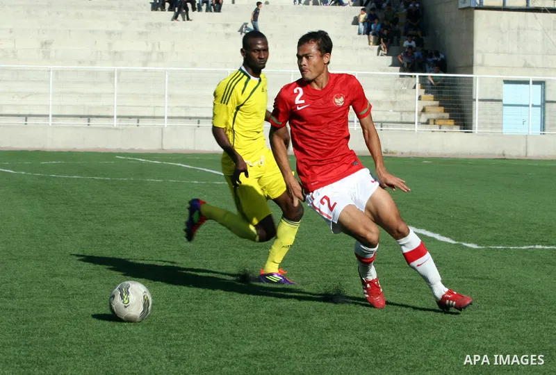 Mauritanian and Indonesian footballers fight for possession during a football match. Mauritanian and Indonesian footballers face-off during the Nakba Championship in the West Bank city of Nablus, on May 17, 2012. Nakba f...