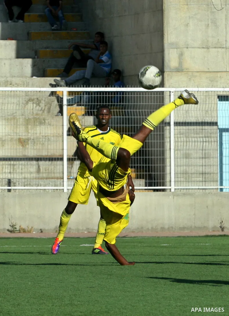 Mauritanian and Indonesian footballers fight for possession during a football match. Mauritanian and Indonesian footballers face-off during the Nakba Championship in the West Bank city of Nablus, on May 17, 2012. Nakba f...