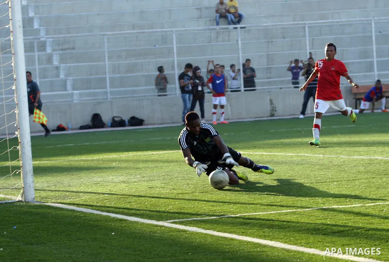 Mauritanian and Indonesian footballers fight for possession during a football match. Mauritanian and Indonesian footballers face-off during the Nakba Championship in the West Bank city of Nablus, on May 17, 2012. Nakba f...