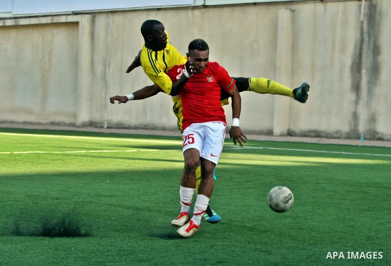 Mauritanian and Indonesian footballers fight for possession during a football match. Mauritanian and Indonesian footballers face-off during the Nakba Championship in the West Bank city of Nablus, on May 17, 2012. Nakba f...