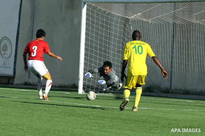 Mauritanian and Indonesian footballers fight for possession during a football match. Mauritanian and Indonesian footballers face-off during the Nakba Championship in the West Bank city of Nablus, on May 17, 2012. Nakba f...