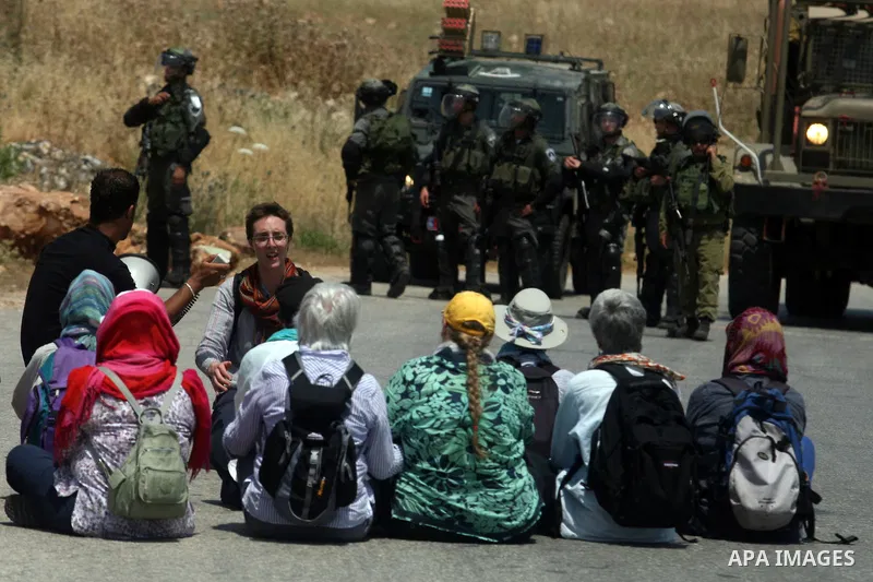 Palestinian and Foreign protesters, set on the road during a weekly demonstration in the West Bank, village of Nabi Saleh near Ramallah on Friday, May 18, 2012. Photo by Issam Rimawi