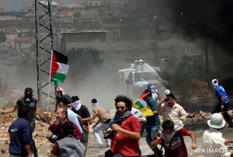 Israeli truck spray foul smelling water towards Palestinians during clashes in the northern West Bank village of Kufr Qaddum, near the Jewish settlement of Kdumim, Friday, May 18, 2012. Photo by Wagdi Eshtayah