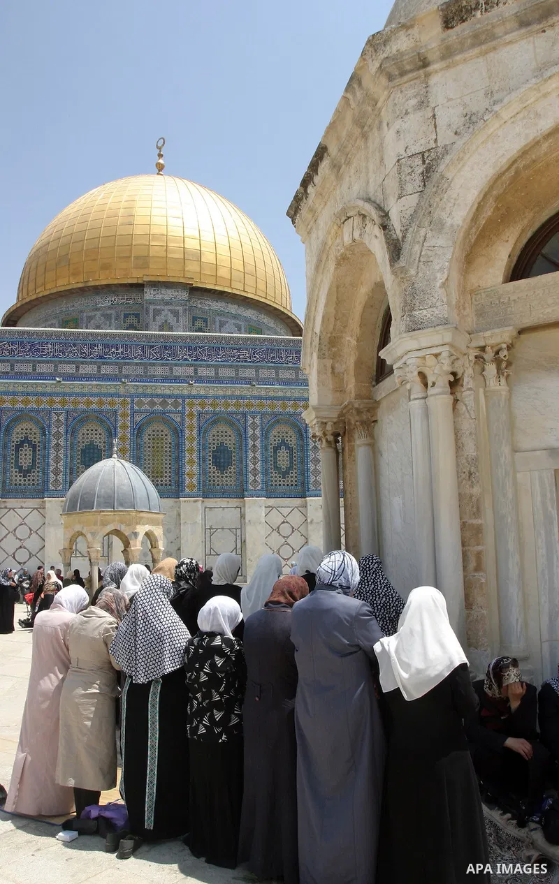 Palestinian worshippers pray outside the Dome of the Rock at the Al-Aqsa Mosque compound in in Jerusalem's old city on May 18, 2012. Photo by Mahfouz Abu Turk