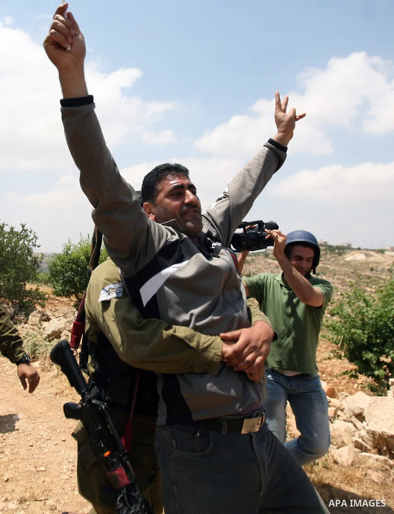 Palestinians wave their national flag during a demonstration a protest in Beit Amer village, north of the West Bank town of Hebron, on May 19, 2012 where Israeli soldiers tried to evacuate demonstrators by force and arre...