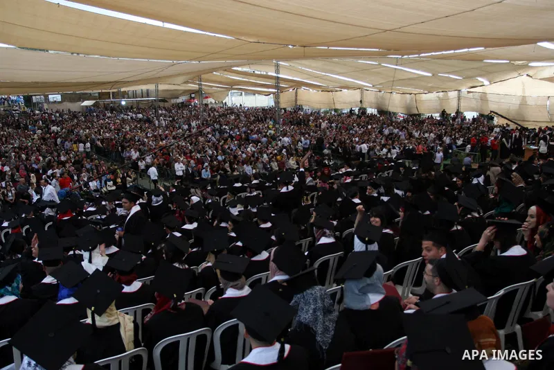 Palestinian students attend their graduation ceremony at the Birzeit University near the West Bank city of Ramallah. as some 3000 students received their degrees at the end of the academic year on May 19, 2012. Photo by...