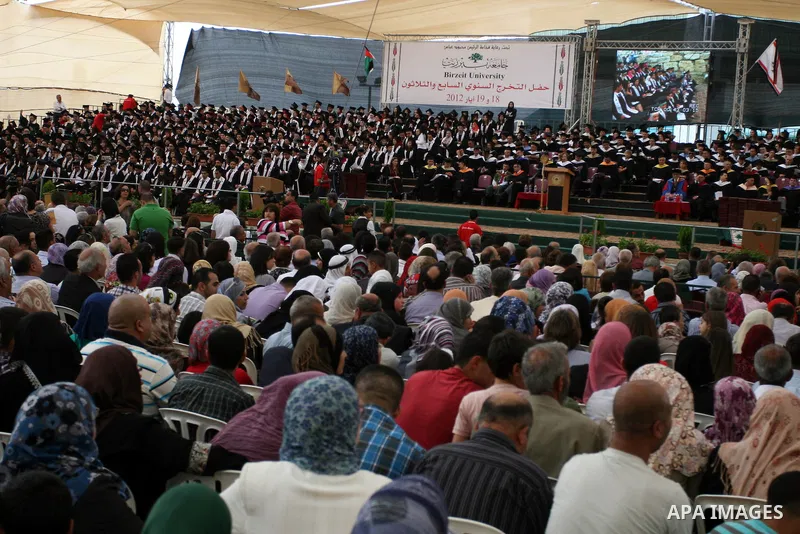 Palestinian students attend their graduation ceremony at the Birzeit University near the West Bank city of Ramallah. as some 3000 students received their degrees at the end of the academic year on May 19, 2012. Photo by...