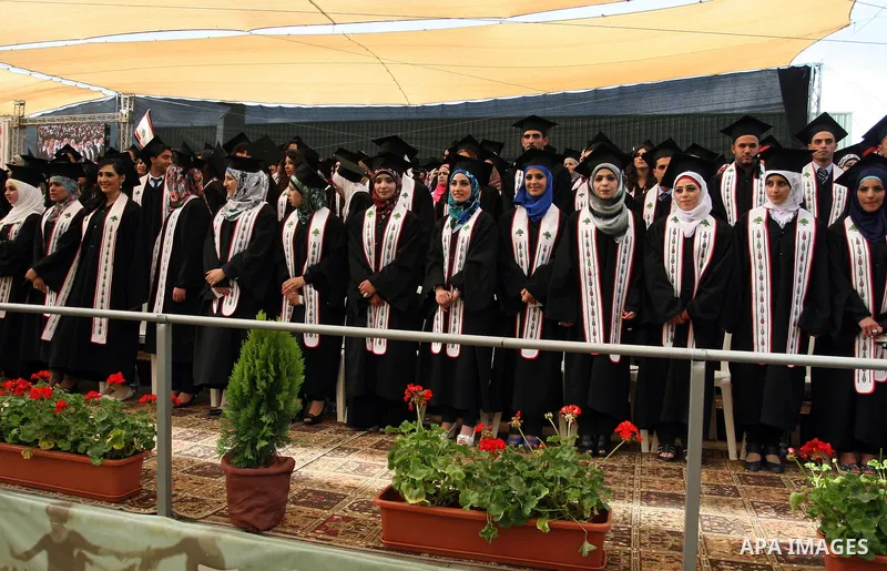 Palestinian students attend their graduation ceremony at the Birzeit University near the West Bank city of Ramallah. as some 3000 students received their degrees at the end of the academic year on May 19, 2012. Photo by...