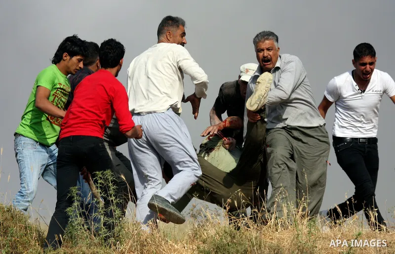 Palestinians carry an injured man, during clashes between Israeli settler from the Jewish settlement of Yitzhar and Palestinians from the village of Asira al-Qibiliya, south of the northern West Bank city of Nablus on Ma...