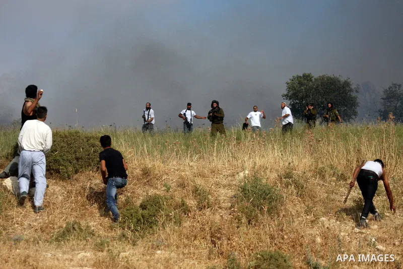 Palestinians from the village of Asira al-Qibiliya throw stones during clashes with Israeli settlers from the Jewish settlement of Yitzhar, south of the northern West Bank city of Nablus on May 19, 2012. The Israeli army...