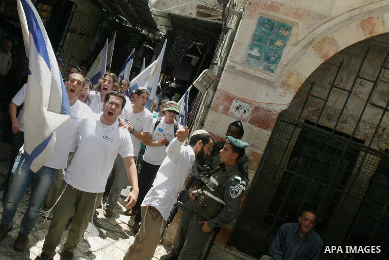 Israelis march and dance in the old city of Jerusalem on May 20, 2012 during Jerusalem Day celebrations marking the Jewish state's capture of the Arab eastern sector 45 years ago during the Six-Day War. Photo by Mahfouz...