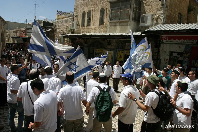 Israelis march and dance in the old city of Jerusalem on May 20, 2012 during Jerusalem Day celebrations marking the Jewish state's capture of the Arab eastern sector 45 years ago during the Six-Day War. Photo by Mahfouz...
