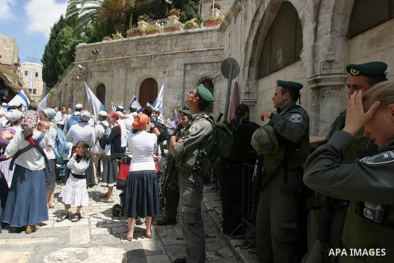 Israelis march and dance in the old city of Jerusalem on May 20, 2012 during Jerusalem Day celebrations marking the Jewish state's capture of the Arab eastern sector 45 years ago during the Six-Day War. Photo by Mahfouz...