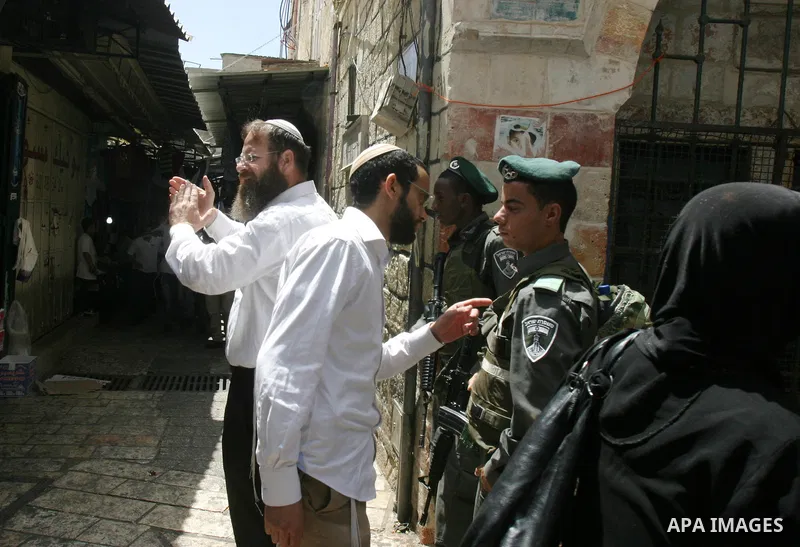 Israelis march and dance in the old city of Jerusalem on May 20, 2012 during Jerusalem Day celebrations marking the Jewish state's capture of the Arab eastern sector 45 years ago during the Six-Day War. Photo by Mahfouz...