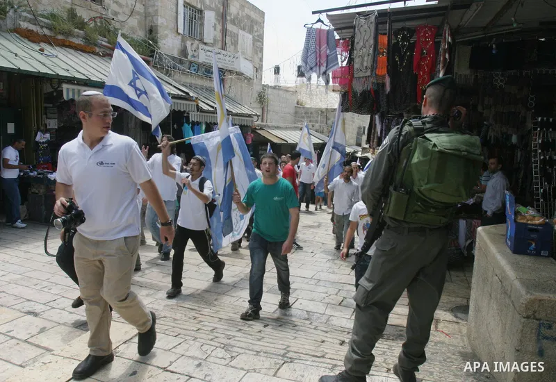 Israelis march and dance in the old city of Jerusalem on May 20, 2012 during Jerusalem Day celebrations marking the Jewish state's capture of the Arab eastern sector 45 years ago during the Six-Day War. Photo by Mahfouz...