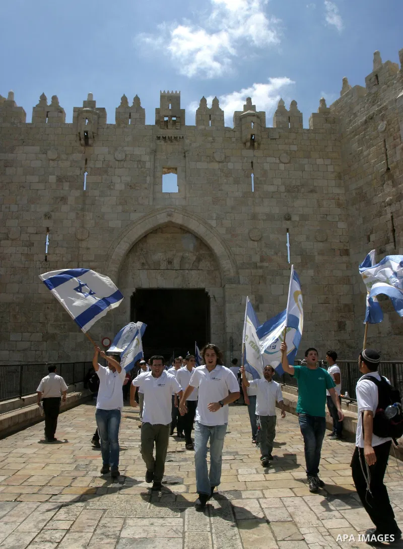 Israelis march and dance in the old city of Jerusalem on May 20, 2012 during Jerusalem Day celebrations marking the Jewish state's capture of the Arab eastern sector 45 years ago during the Six-Day War. Photo by Mahfouz...