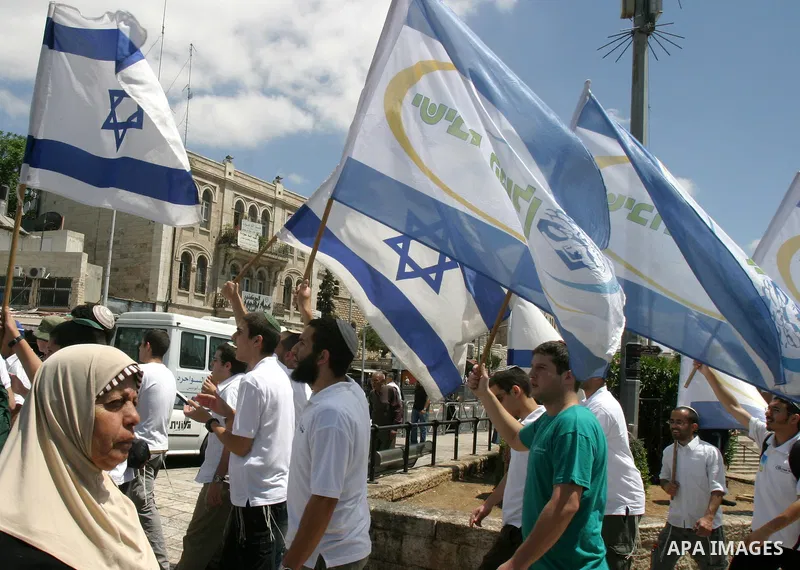 Israelis march and dance in the old city of Jerusalem on May 20, 2012 during Jerusalem Day celebrations marking the Jewish state's capture of the Arab eastern sector 45 years ago during the Six-Day War. Photo by Mahfouz...