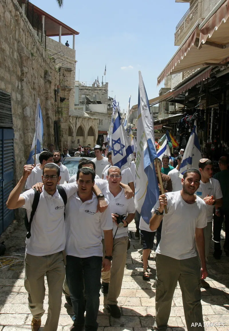 Israelis march and dance in the old city of Jerusalem on May 20, 2012 during Jerusalem Day celebrations marking the Jewish state's capture of the Arab eastern sector 45 years ago during the Six-Day War. Photo by Mahfouz...