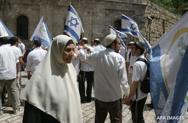 Israelis march and dance in the old city of Jerusalem on May 20, 2012 during Jerusalem Day celebrations marking the Jewish state's capture of the Arab eastern sector 45 years ago during the Six-Day War. Photo by Mahfouz...