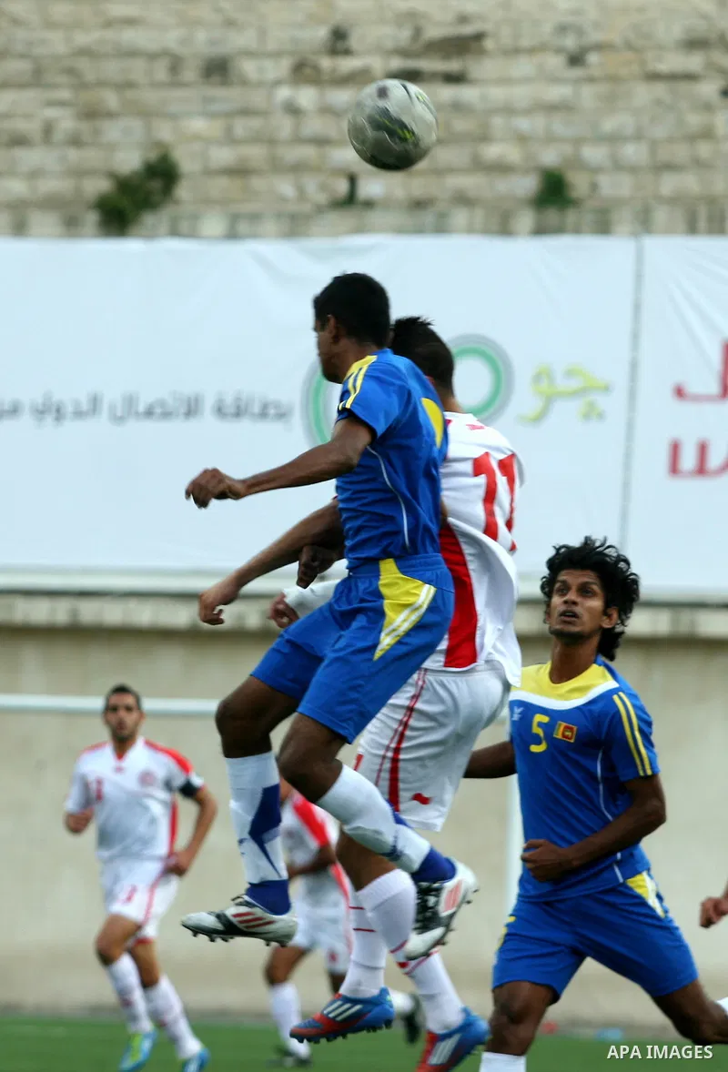Tunisia and Sri Lanka footballers fight for possession during a football match. Tunisia and Sri Lanka footballers face-off during the Nakba Championship in the West Bank city of Nablus, on May 20, 2012. Nakba for the Pal...