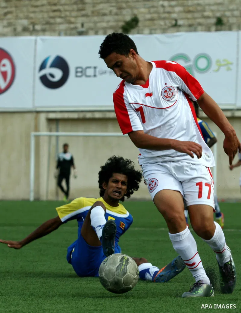 Tunisia and Sri Lanka footballers fight for possession during a football match. Tunisia and Sri Lanka footballers face-off during the Nakba Championship in the West Bank city of Nablus, on May 20, 2012. Nakba for the Pal...