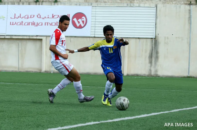 Tunisia and Sri Lanka footballers fight for possession during a football match. Tunisia and Sri Lanka footballers face-off during the Nakba Championship in the West Bank city of Nablus, on May 20, 2012. Nakba for the Pal...