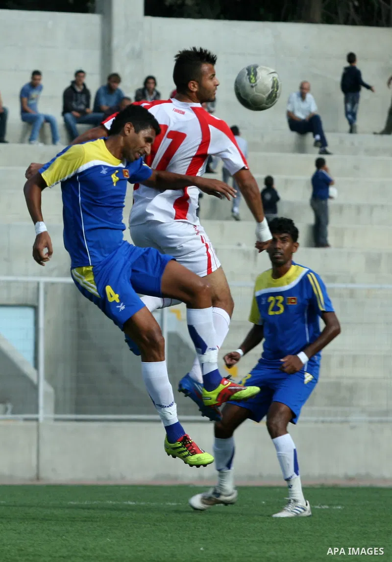 Tunisia and Sri Lanka footballers fight for possession during a football match. Tunisia and Sri Lanka footballers face-off during the Nakba Championship in the West Bank city of Nablus, on May 20, 2012. Nakba for the Pal...