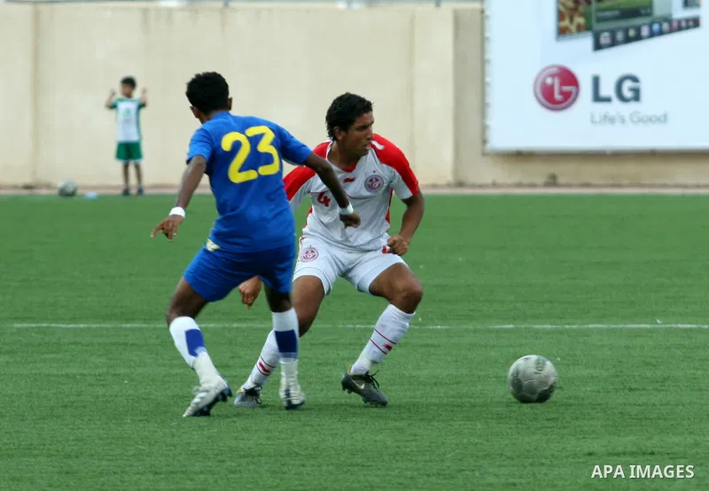 Tunisia and Sri Lanka footballers fight for possession during a football match. Tunisia and Sri Lanka footballers face-off during the Nakba Championship in the West Bank city of Nablus, on May 20, 2012. Nakba for the Pal...